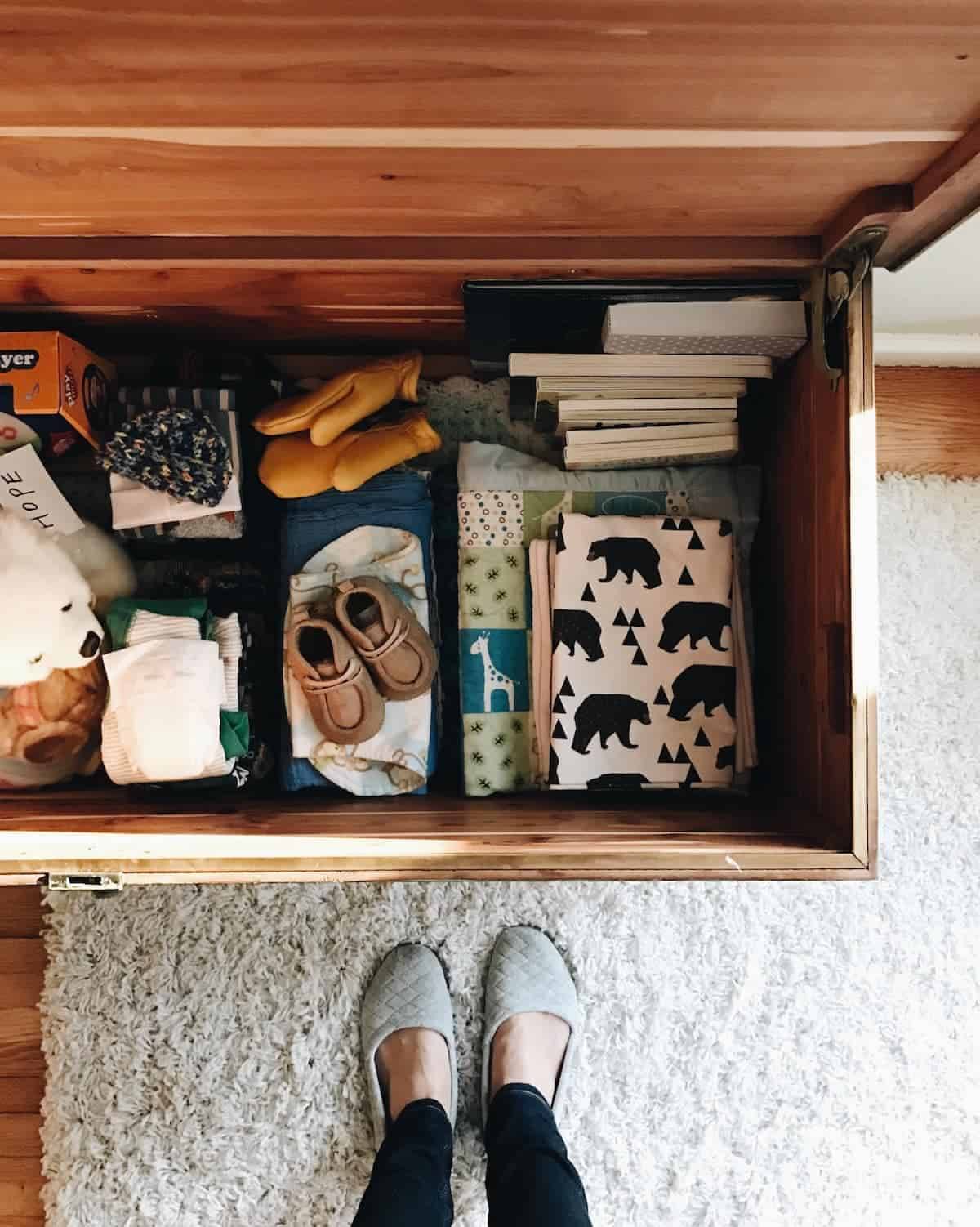 A chest containing books, boots, gloves and other apparel.