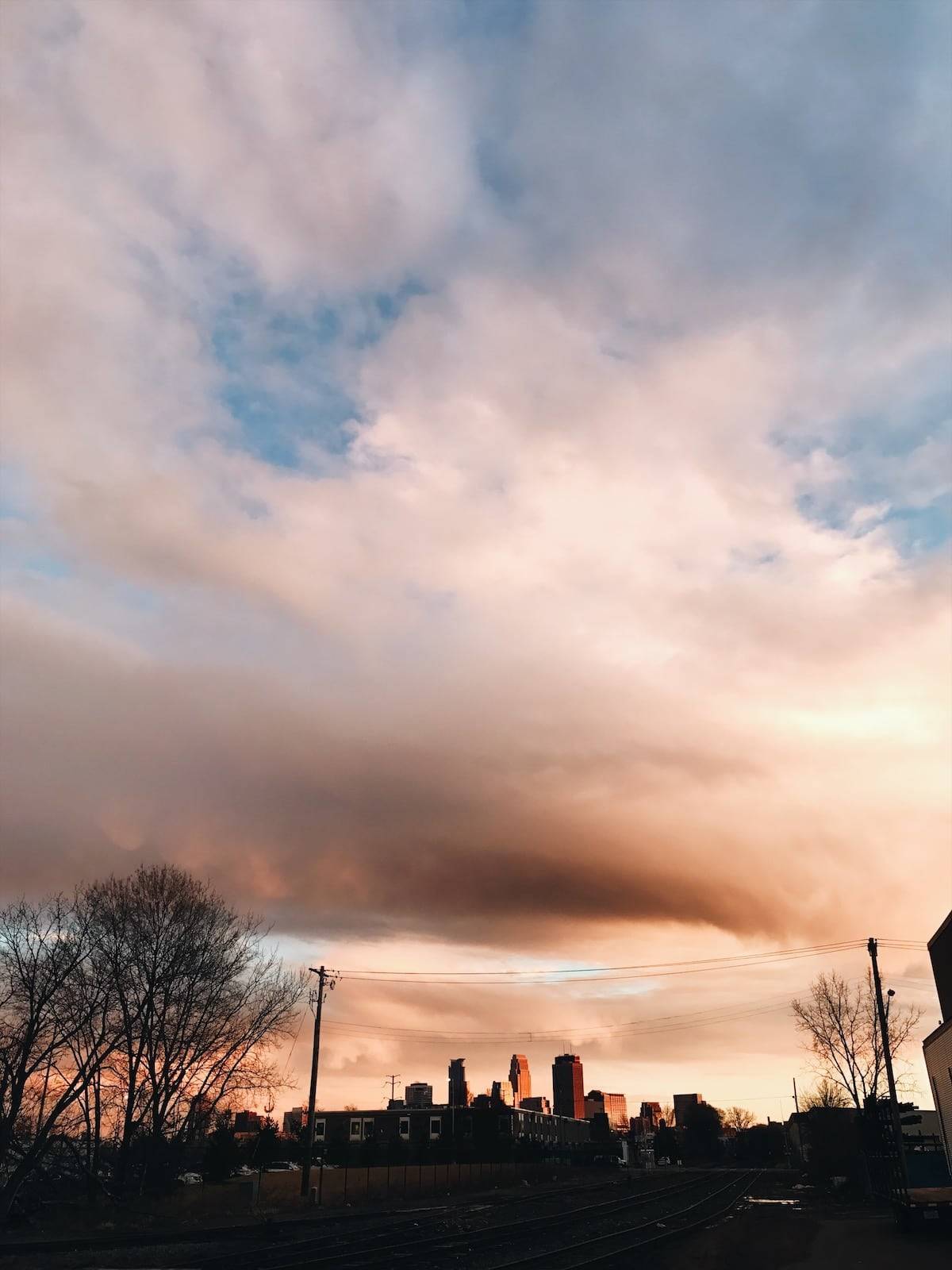 Clouds swirling around in the sky of a small town.