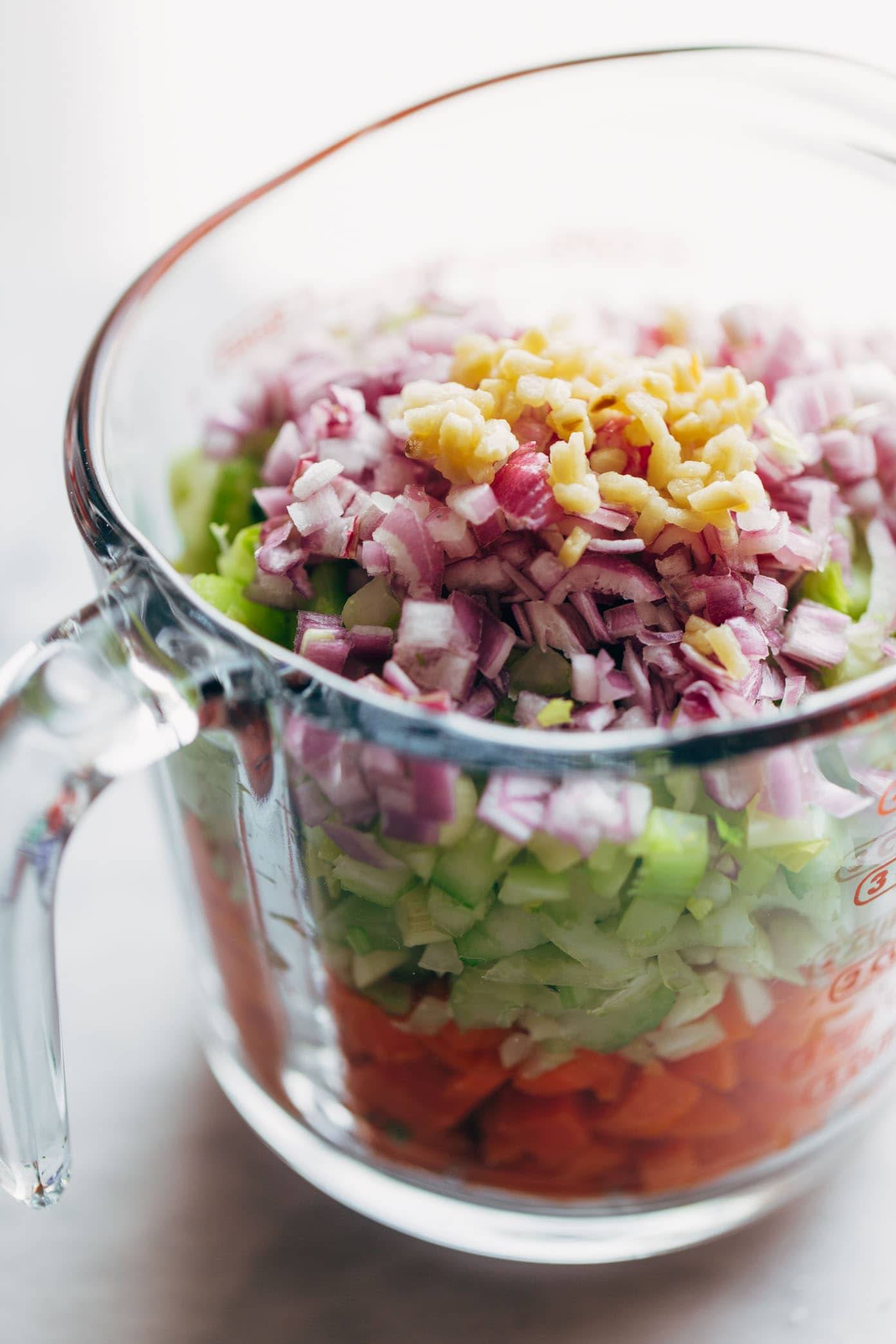 minestrone soup ingredients in a measuring cup