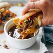 Shredded beef sandwich with au jus in a bowl.