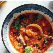 Spoon in a bowl of tomato and bread soup