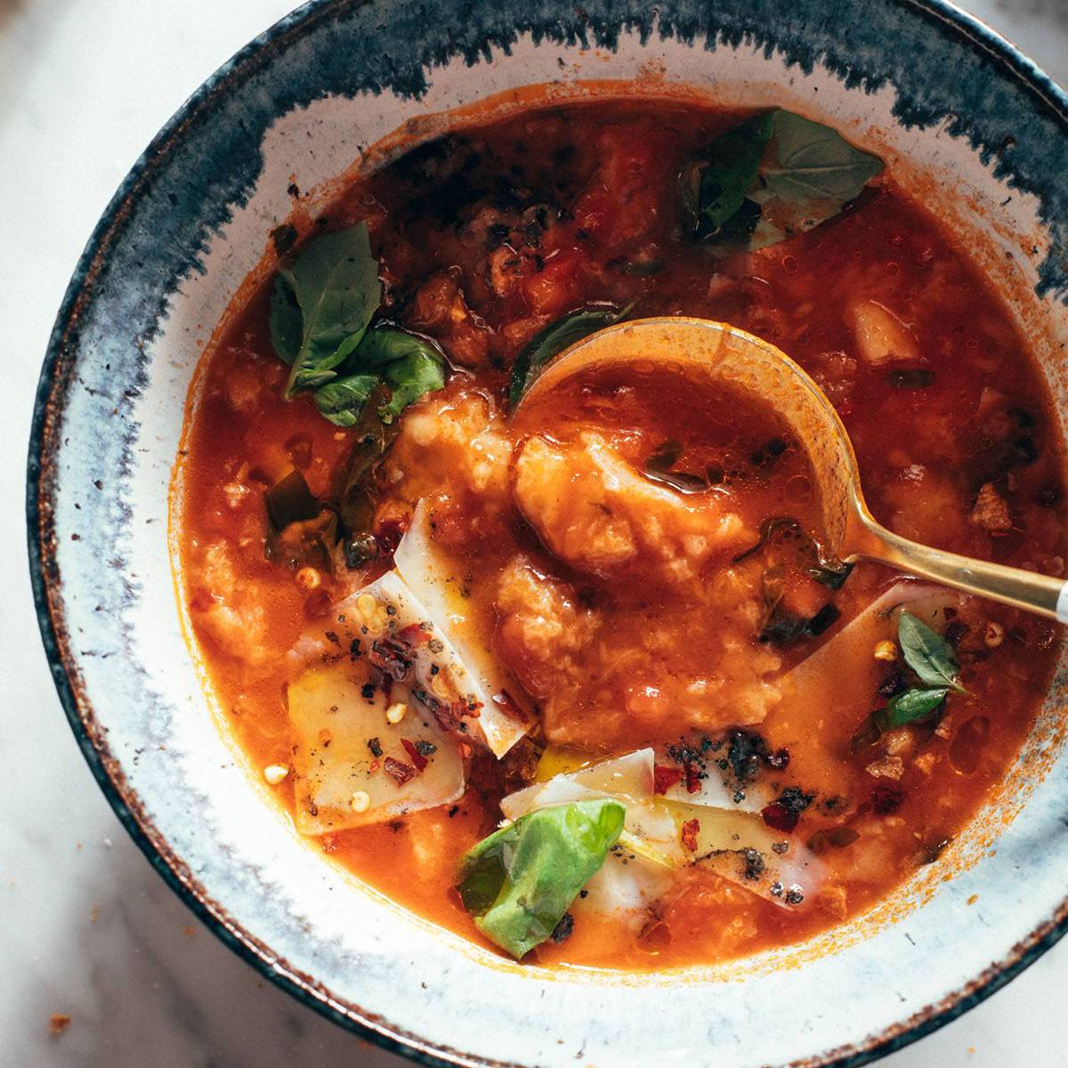 Spoon in a bowl of tomato and bread soup