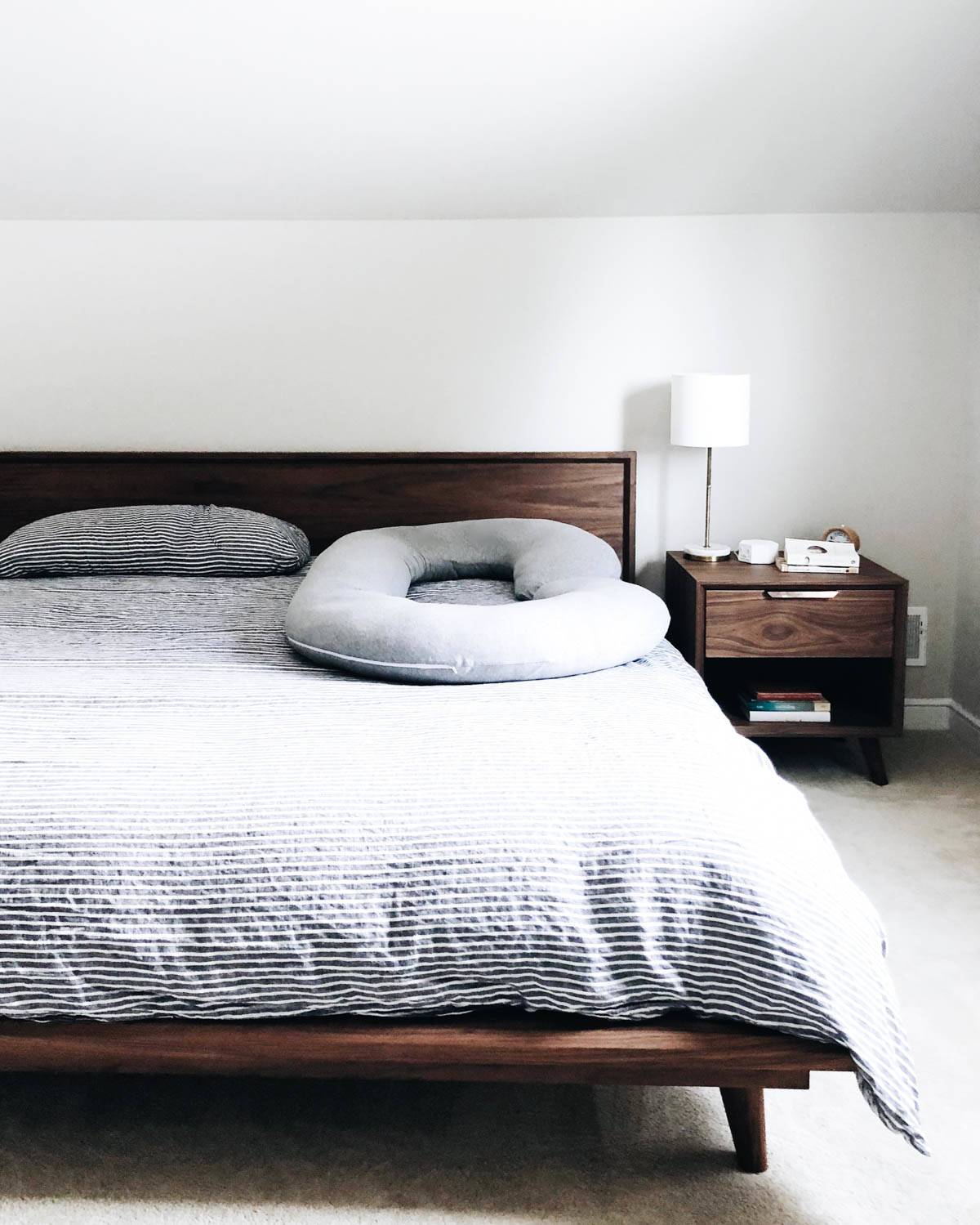 Pregnancy pillow on bed.