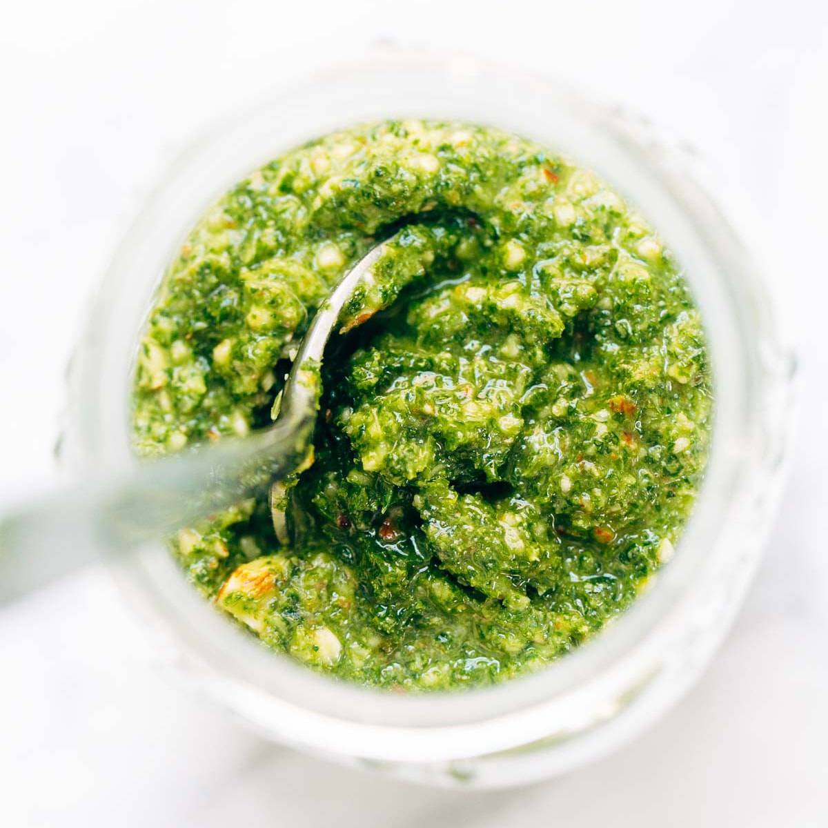 Kale Pesto in a jar with spoon.