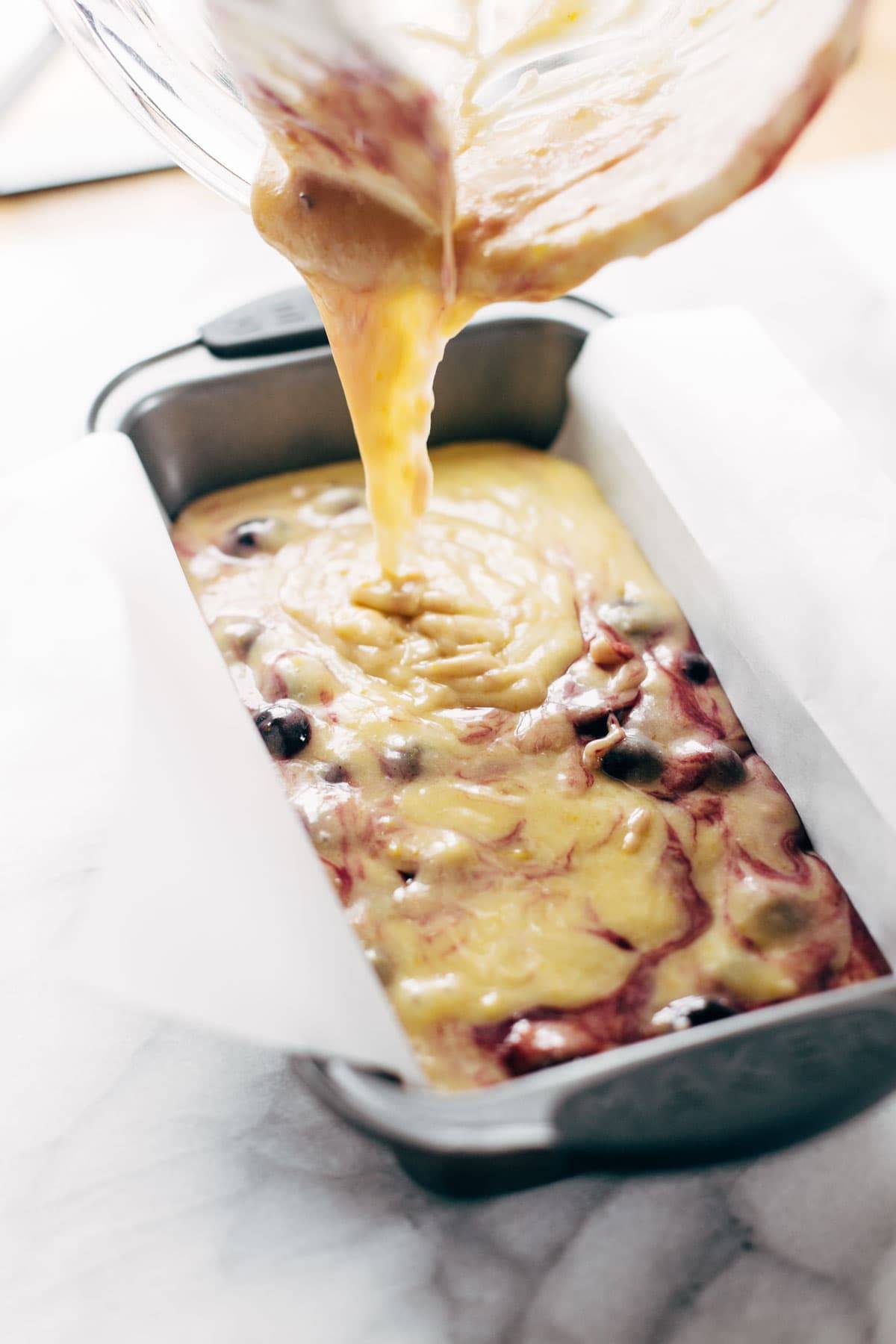 Blueberry Lemon Bread batter being poured into pan.