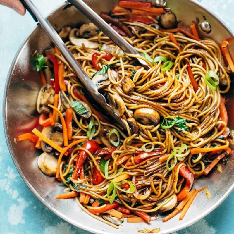 Lo Mein in pan with tongs.