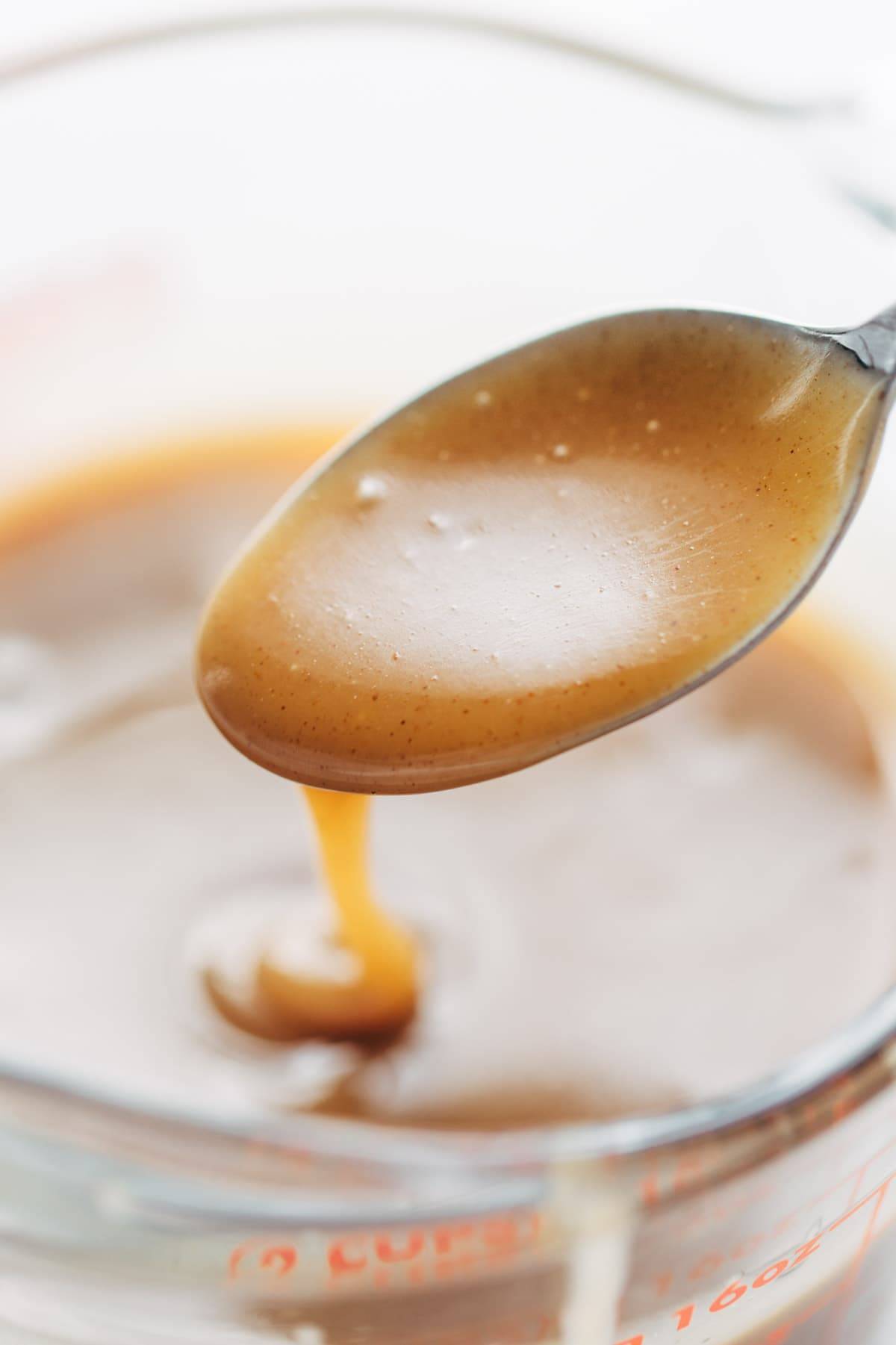 Magic Vegan Caramel Sauce on a spoon.