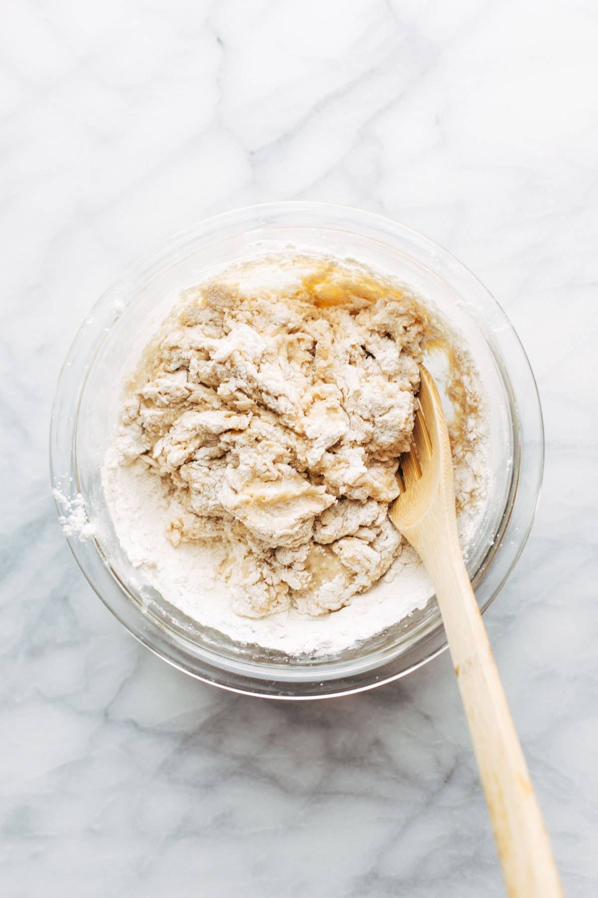 Dough for Basic Soft Pretzels in bowl with spoon.