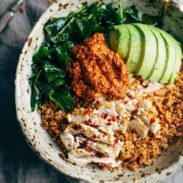 Kale and Chicken bowls with avocado and sauce.