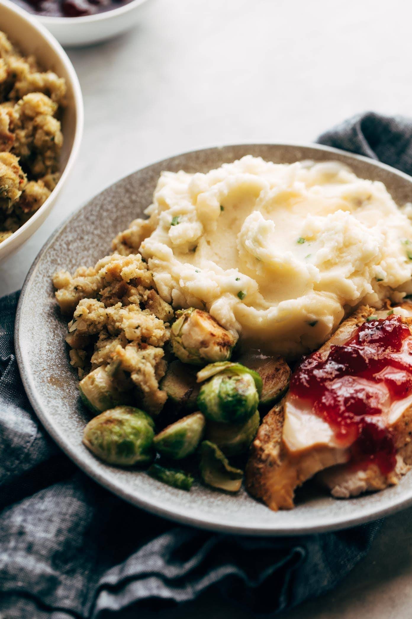 Instant Pot Mashed Potatoes on a plate with stuffing and turkey.