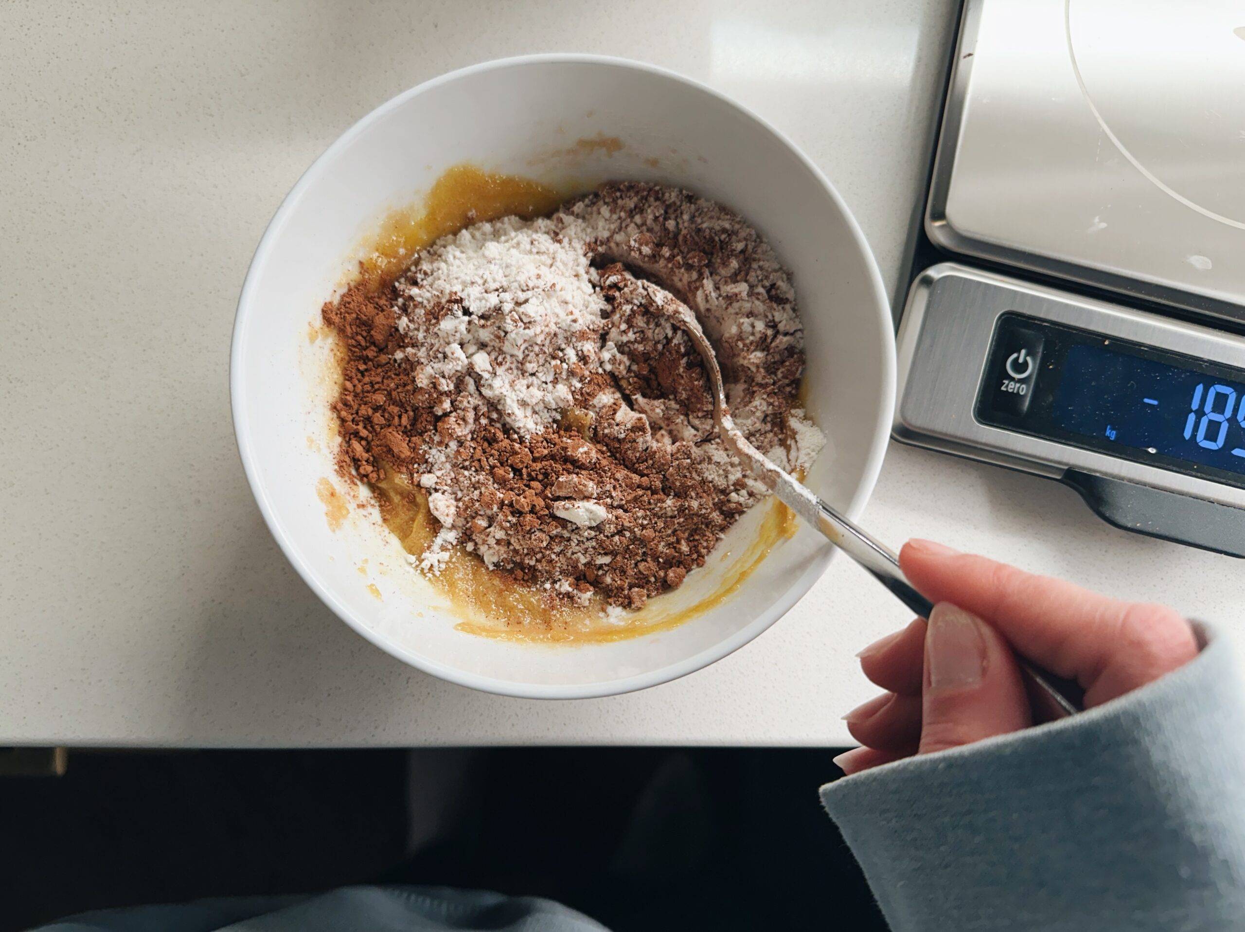 Mixing dough together in a bowl.