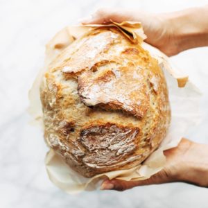 No Knead Bread held by hands.