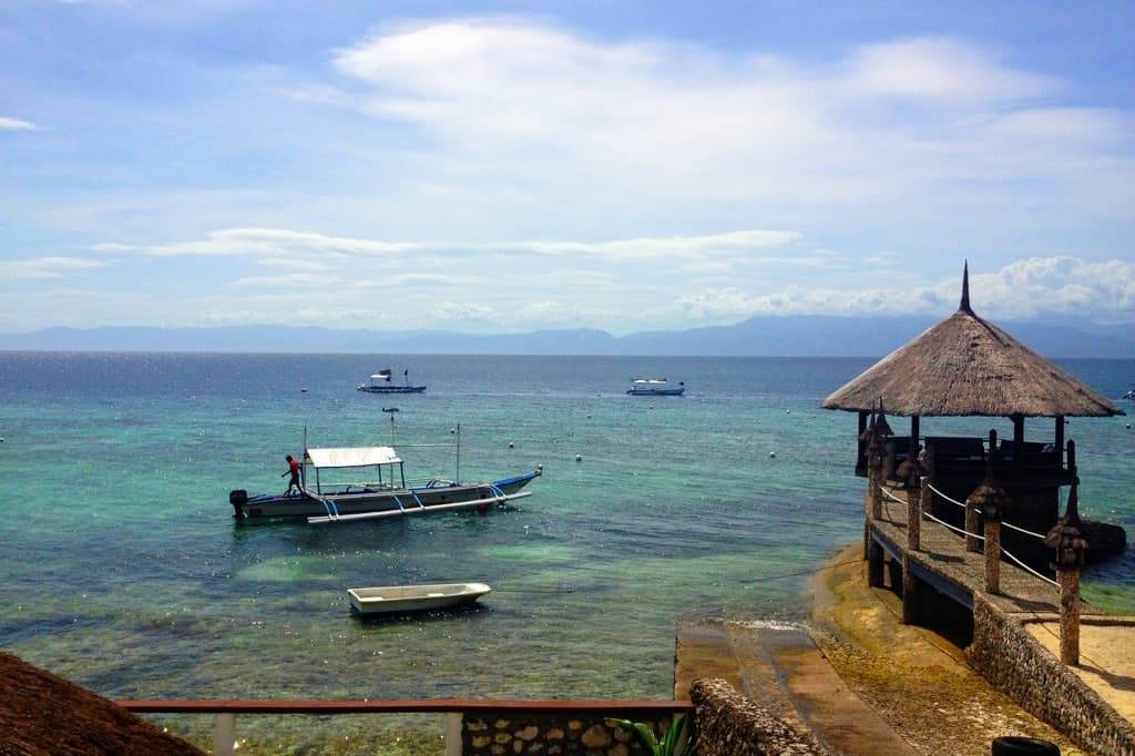 Ocean view with a dock and boats.