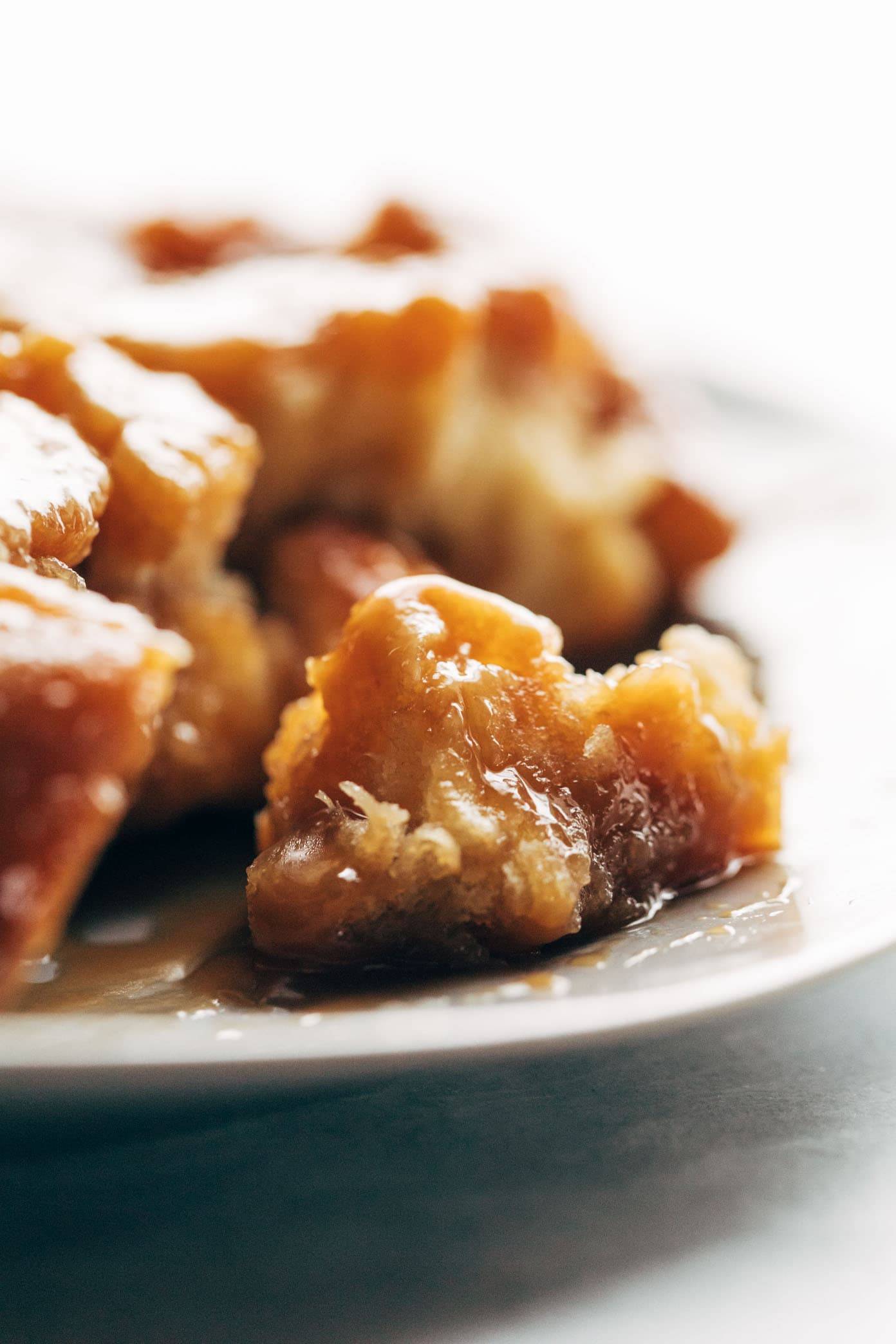 Monkey bread sitting on a white plate.