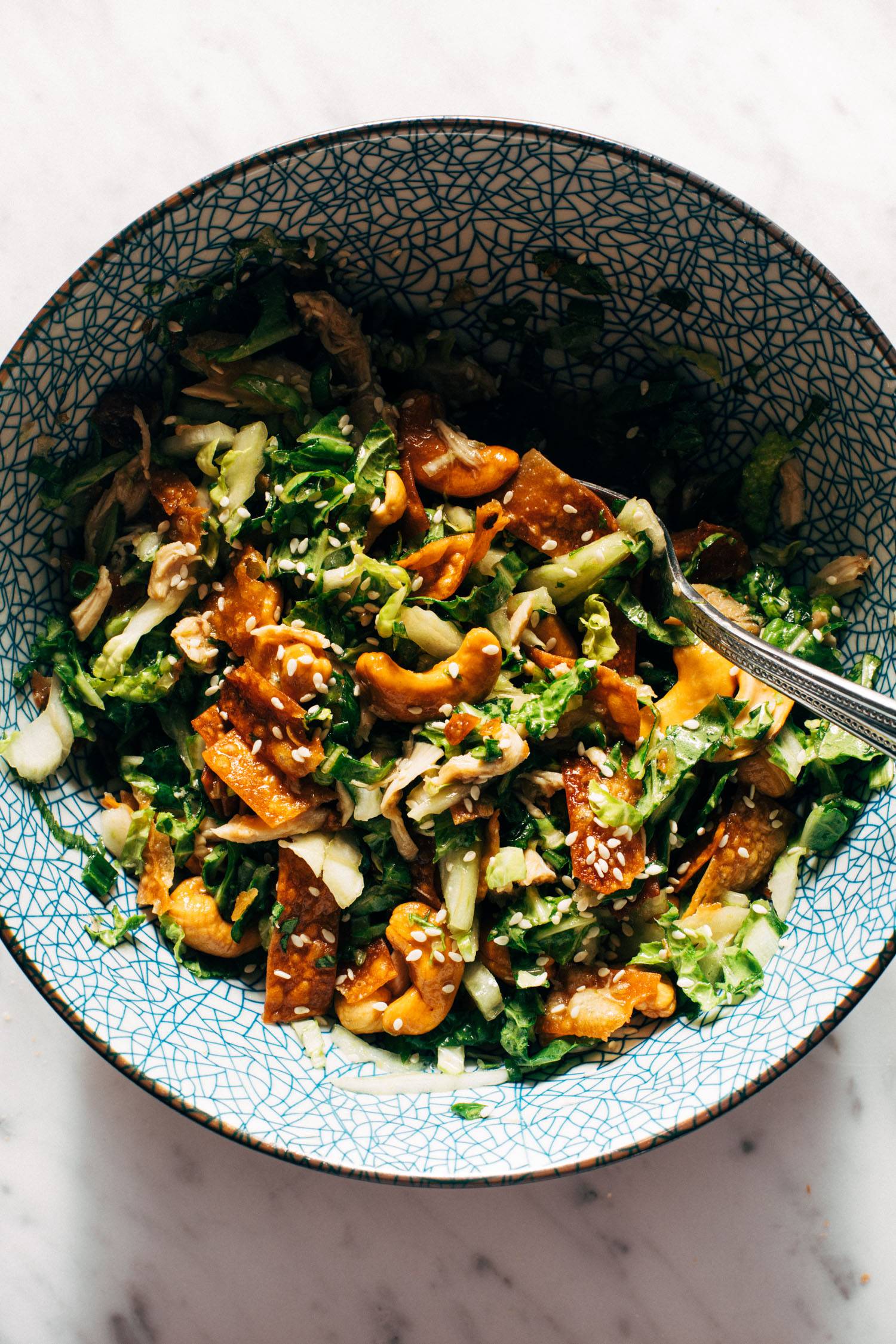 Napa chicken salad in a bowl with a fork