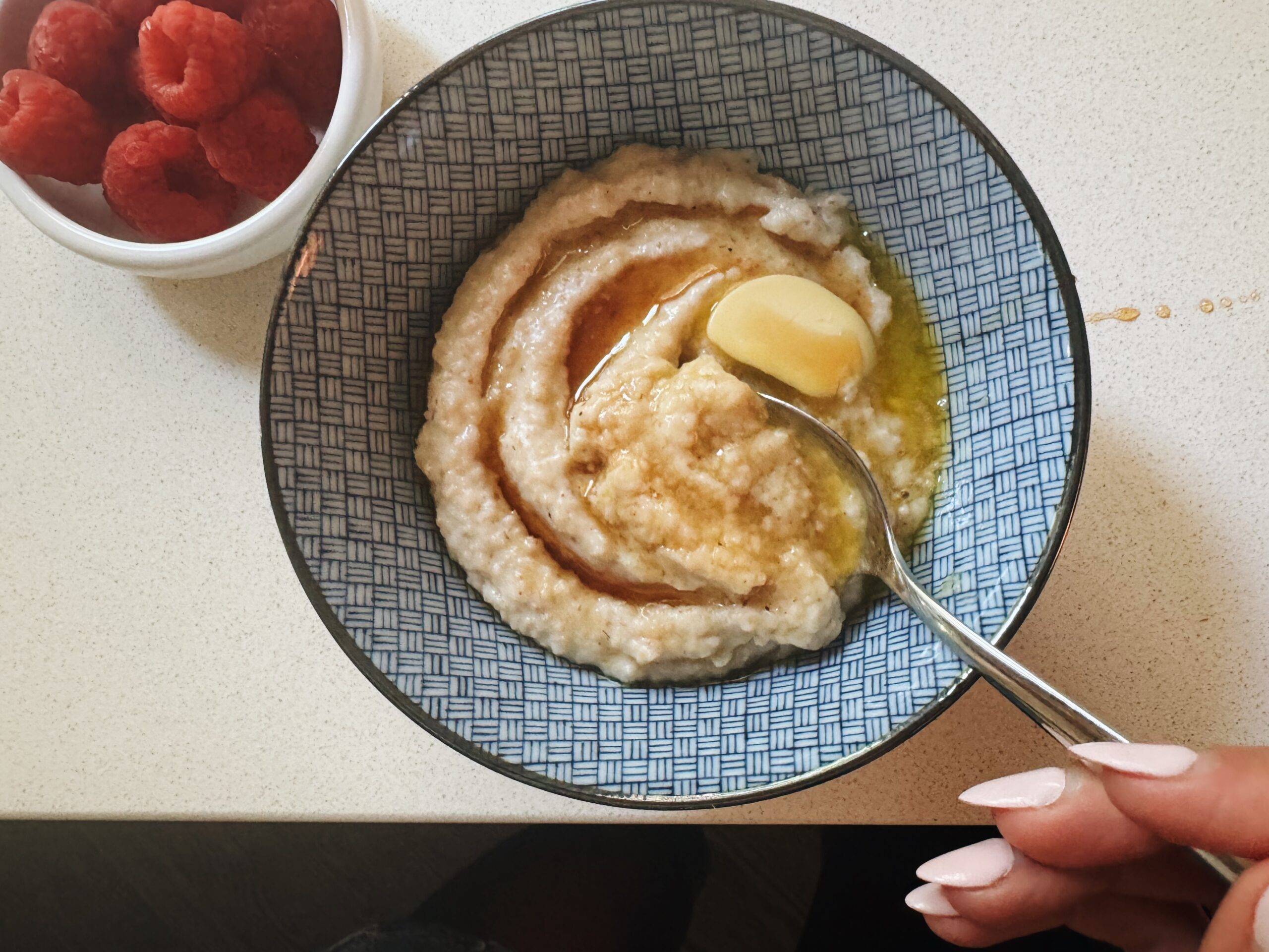 A bowl of oat bran with butter and maple syrup on top.