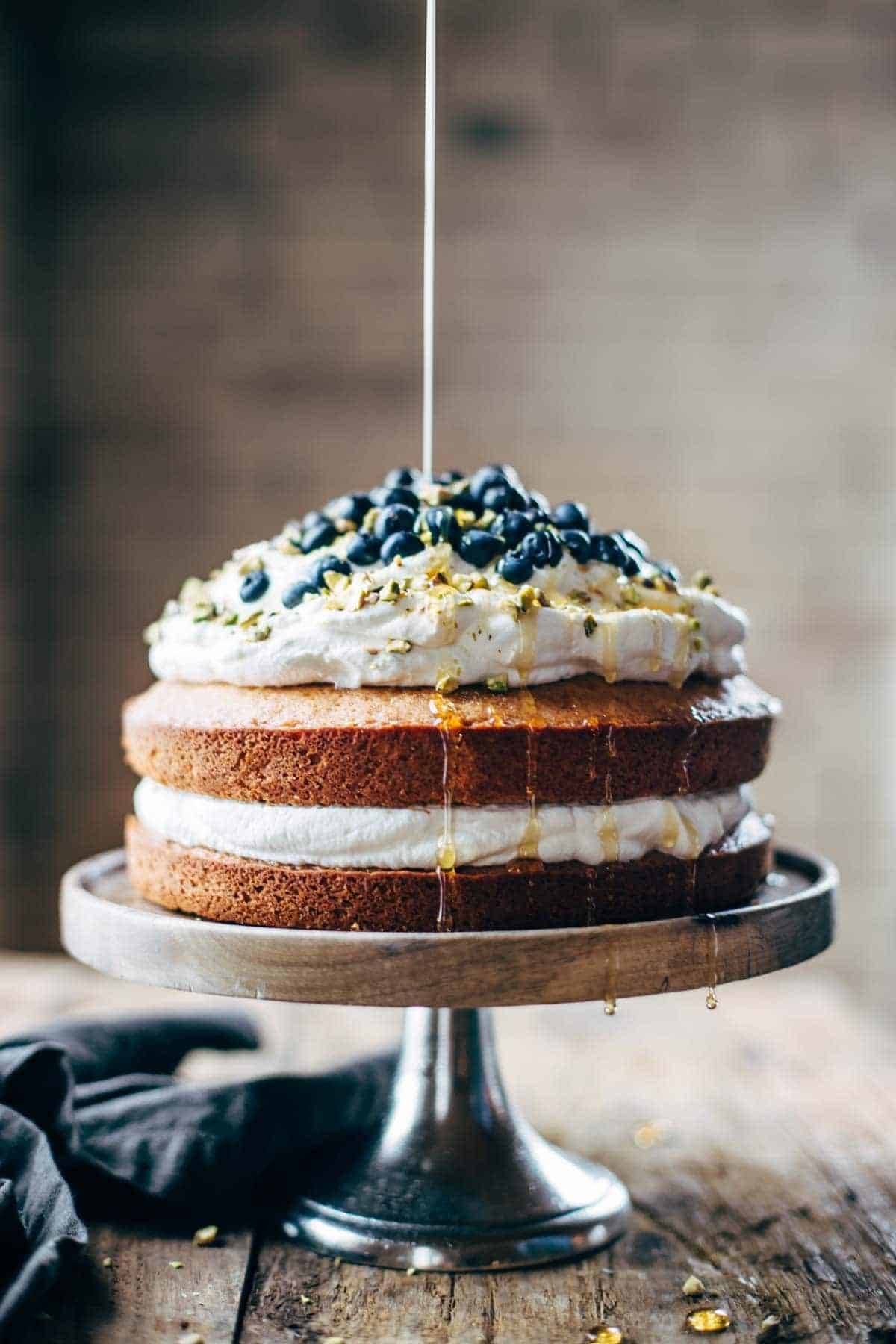 Cake on a cake stand with agave drizzle.