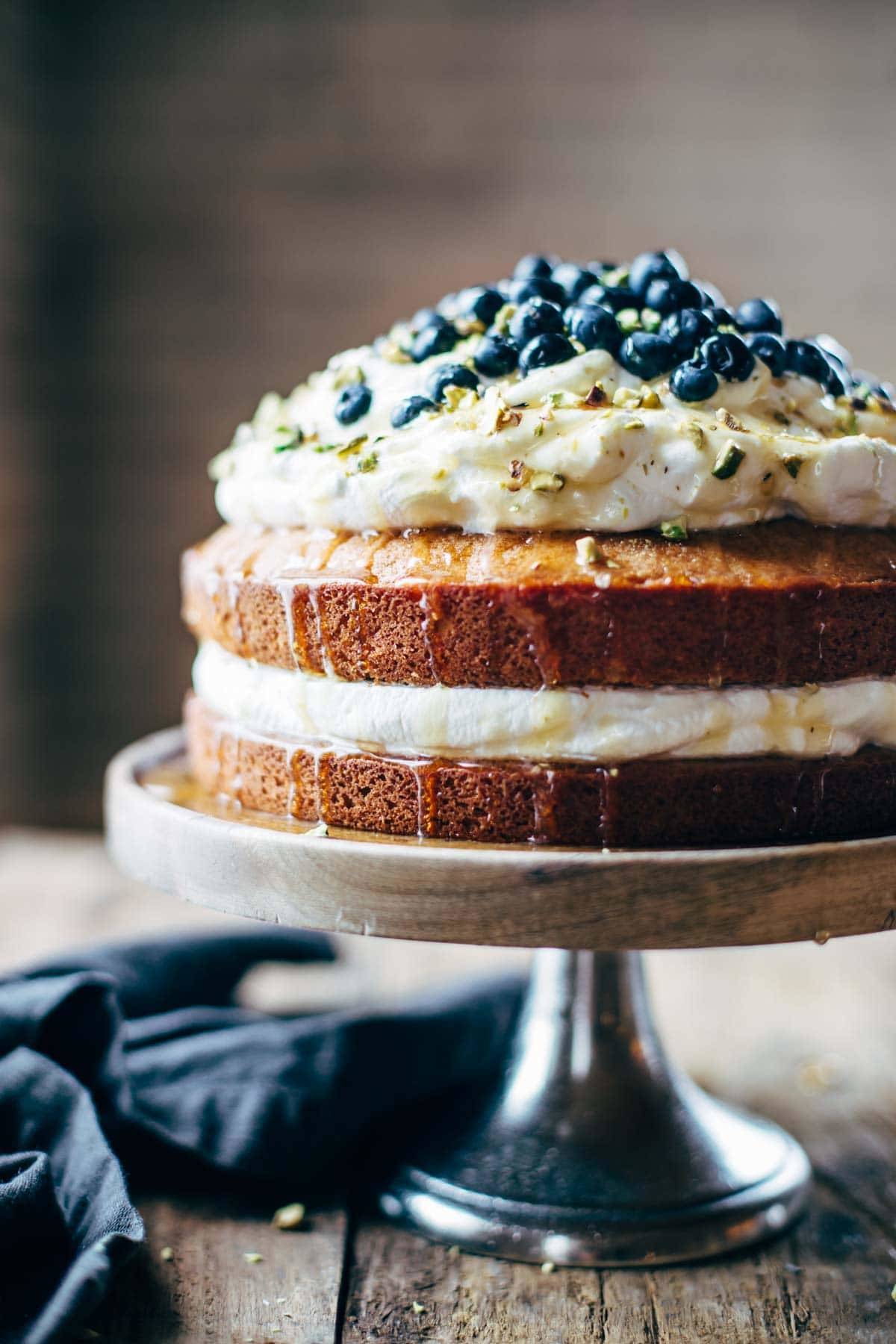 Cake on a cake stand with agave drizzle.