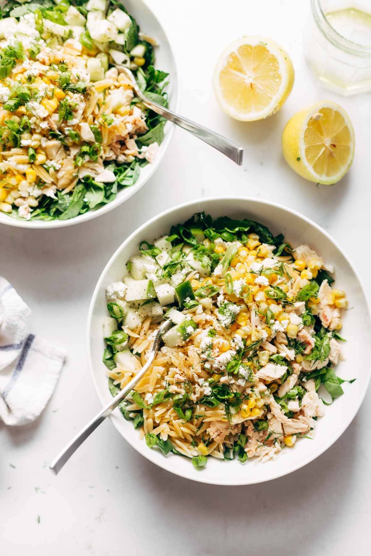 Two bowls of Orzo Summer Salad with forks.