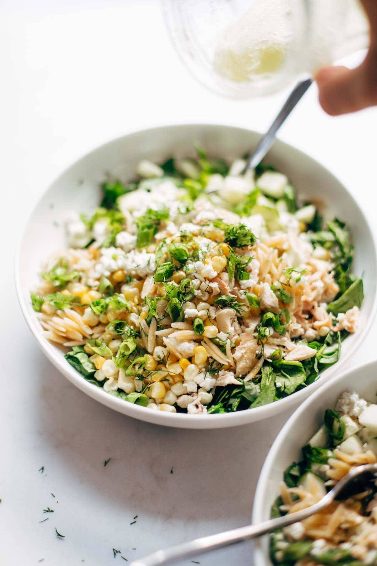 Orzo Summer Salad in a bowl with a fork.