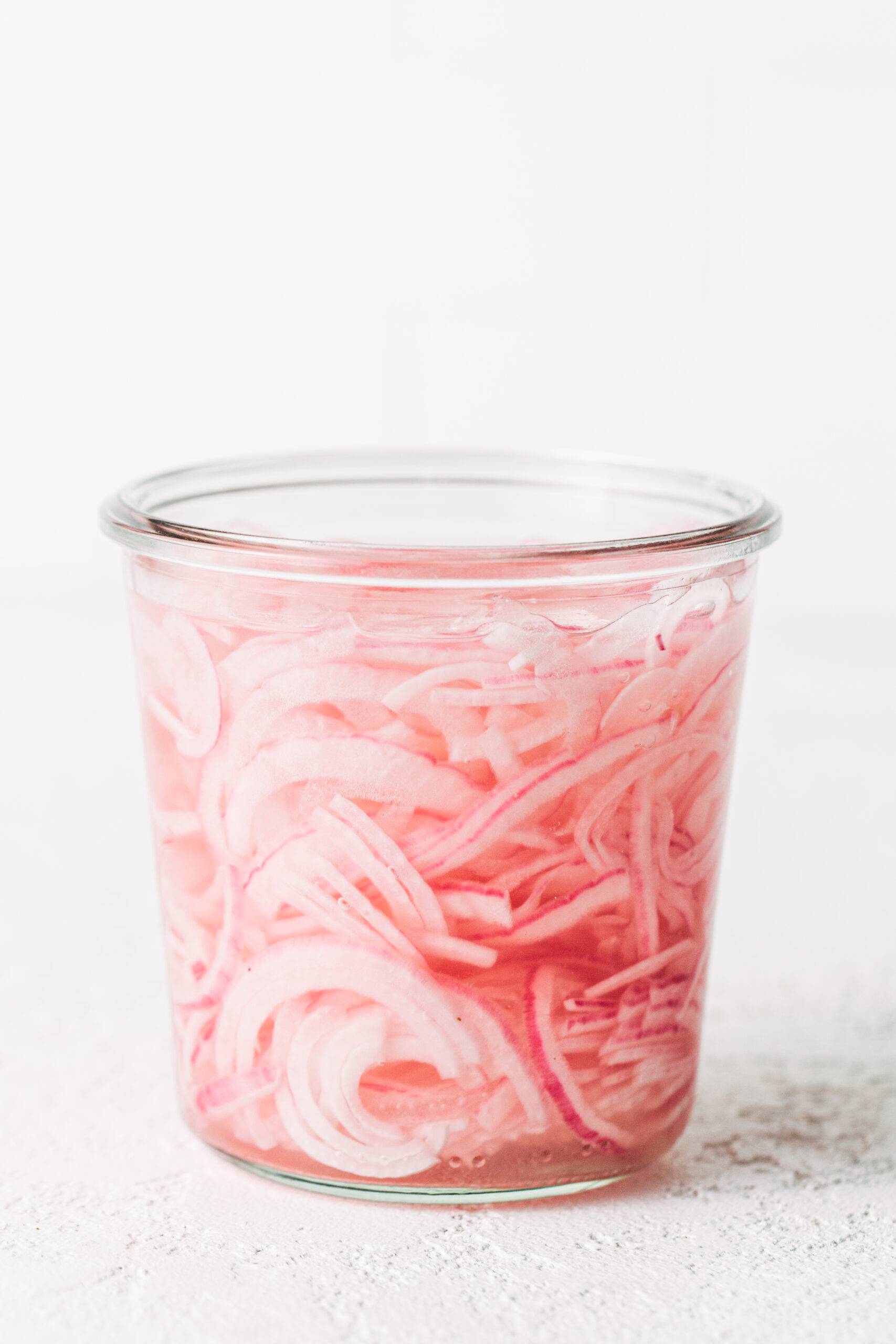 Pickled red onions in a jar