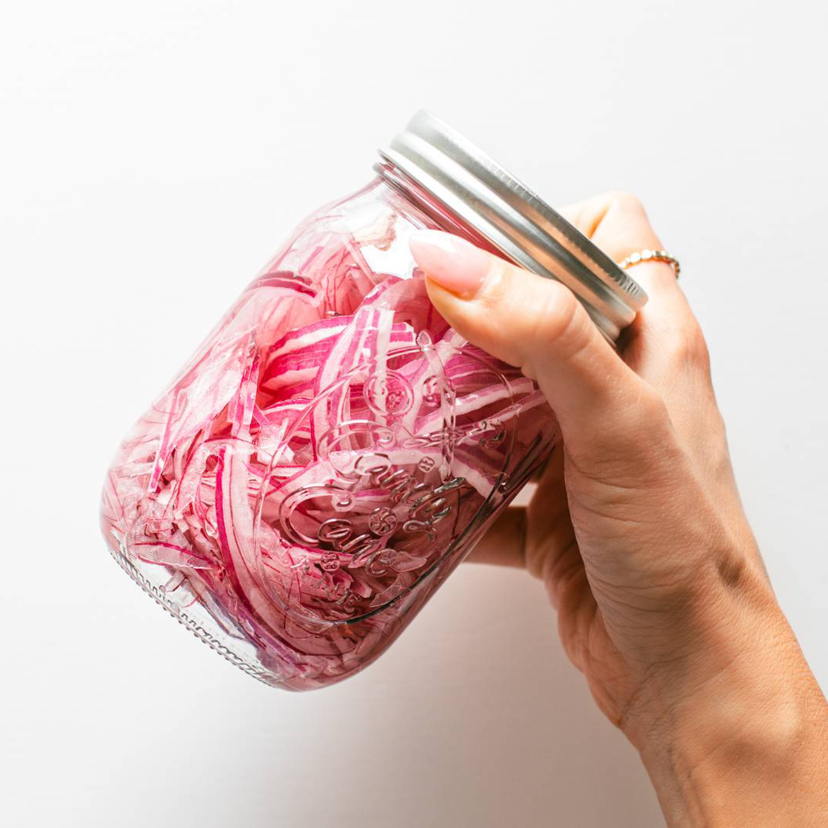 Pickled red onions in a mason jar.