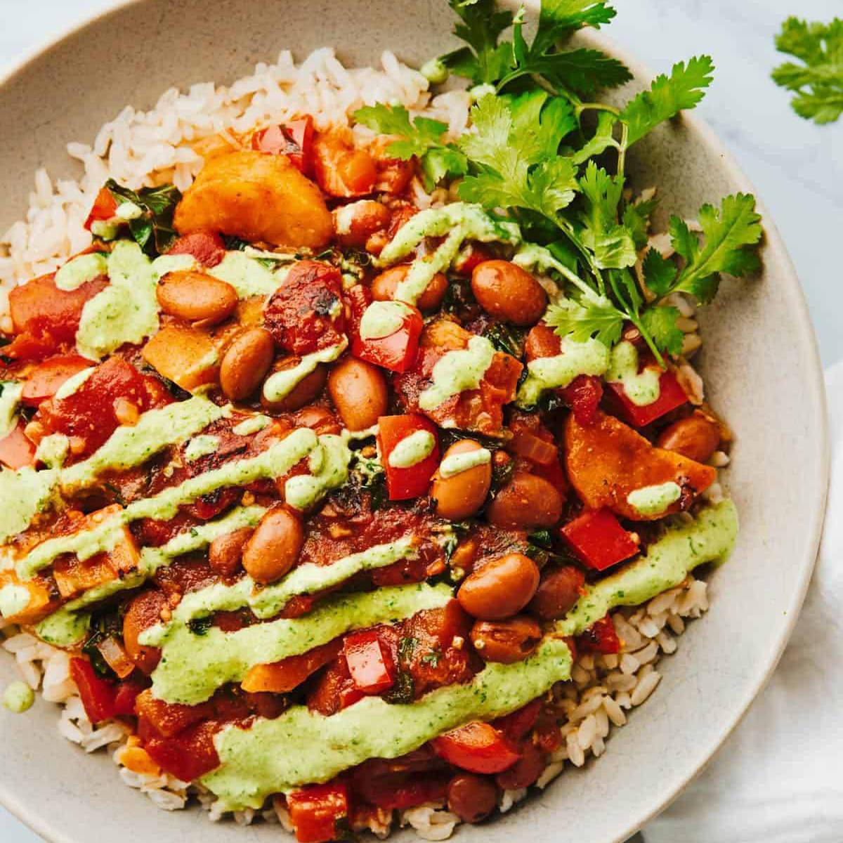 Plantain and pinto stew over rice on a plate