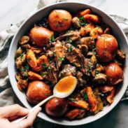 Instant Pot Pot Roast in a bowl with a spoon that has sauce on it.