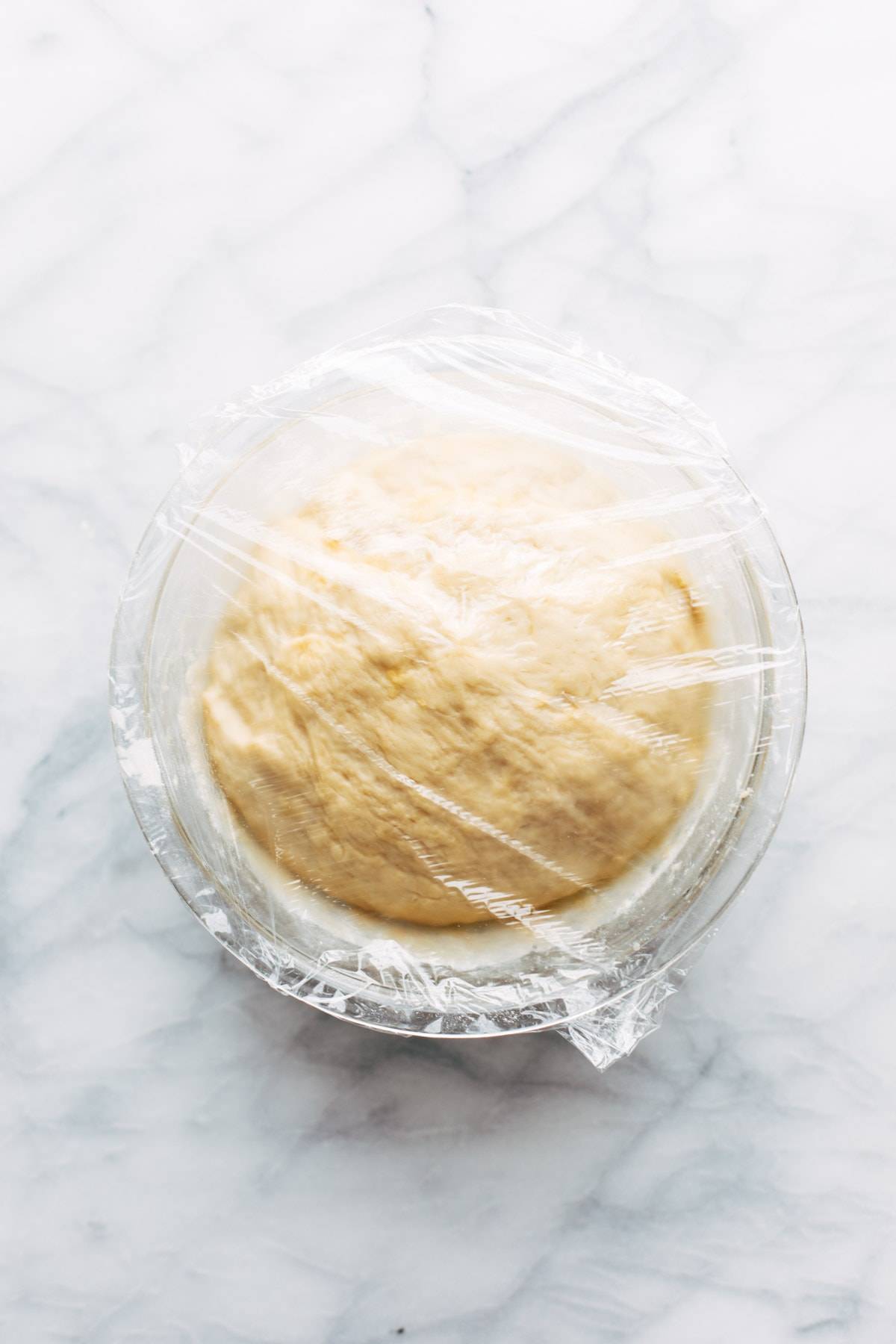 Dough for Basic Soft Pretzels covered in bowl.