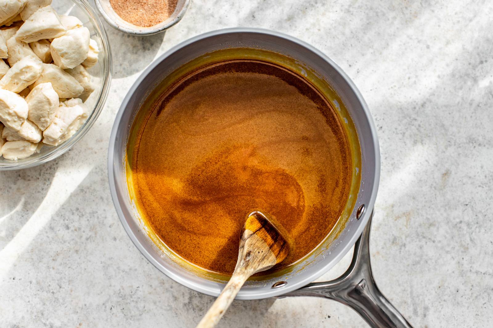 Pumpkin being whisked into caramel sauce