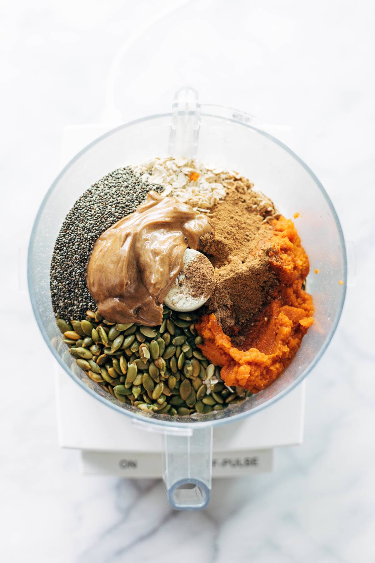 Ingredients for Pumpkin Energy Bites in a food processor.