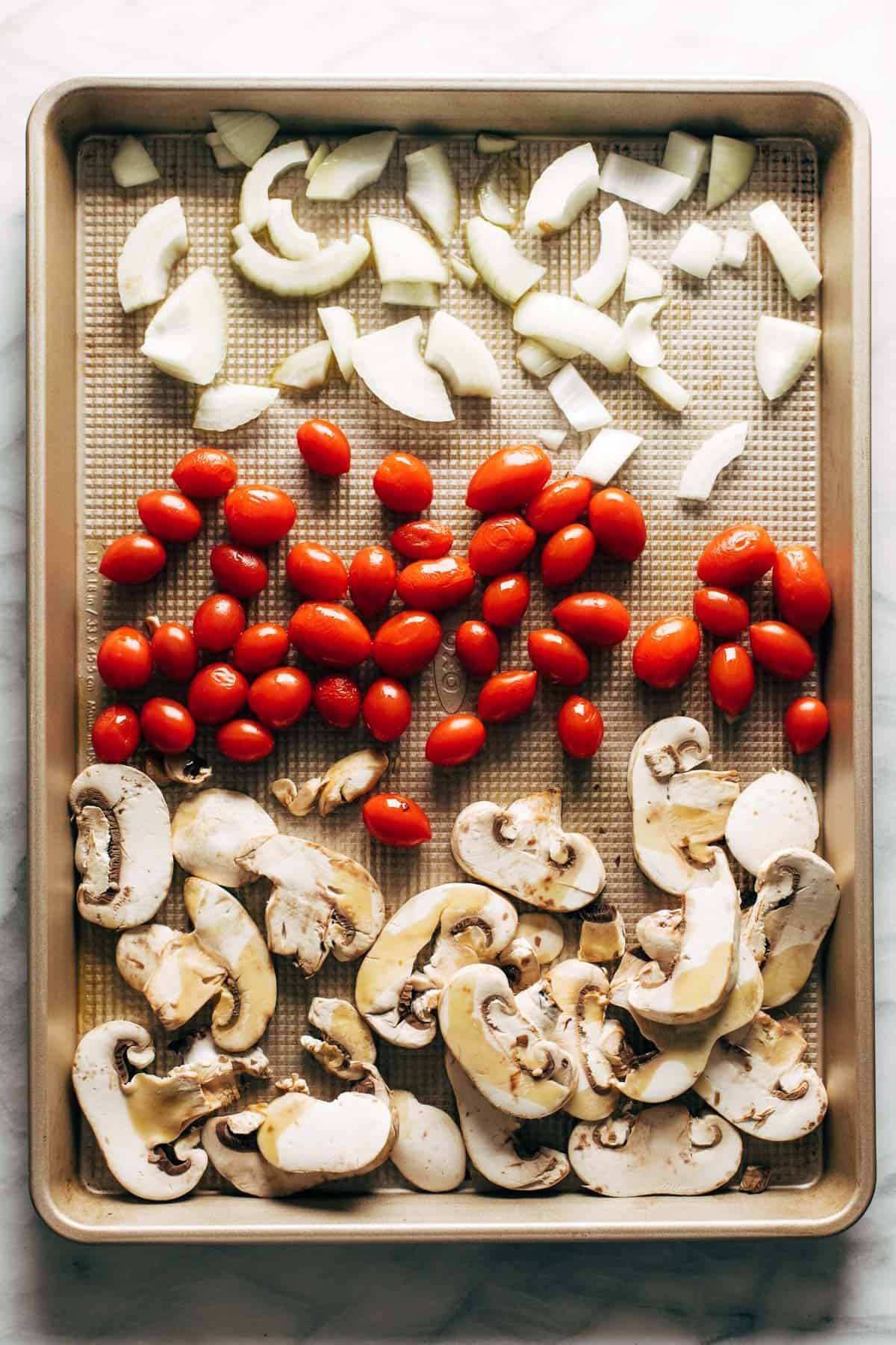 Ingredients for puttanesca on a sheet pan.