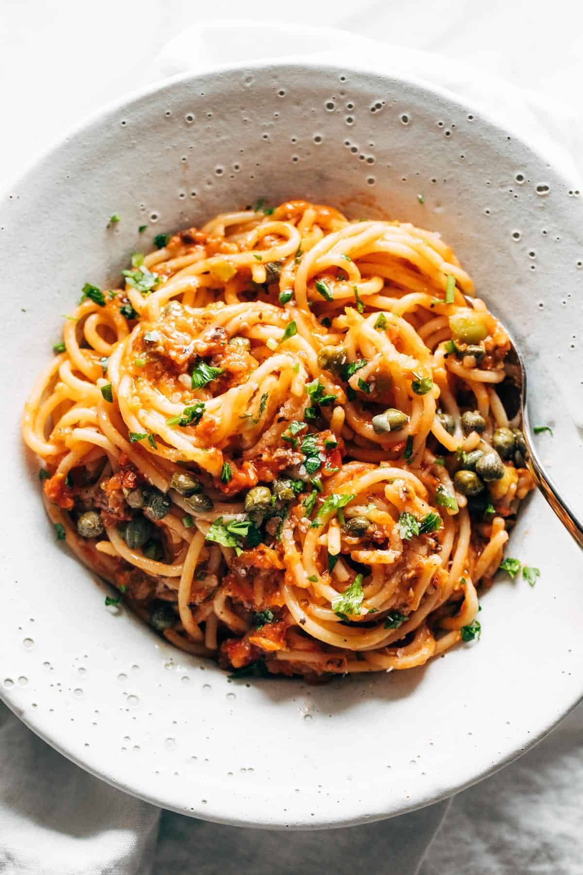 Roasted tomato puttanesca in a bowl.