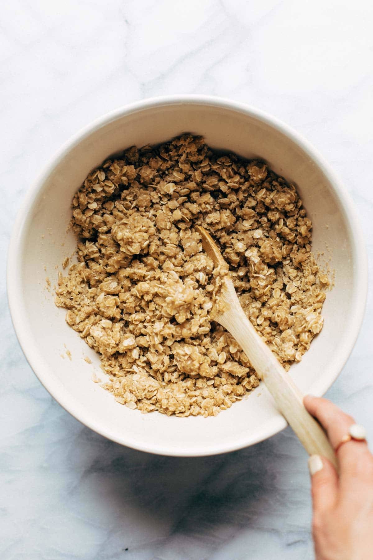 Raspberry Crumble Bars base and topping in bowl with spoon.