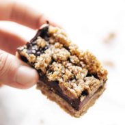 Salted chocolate snack bar held by a hand.