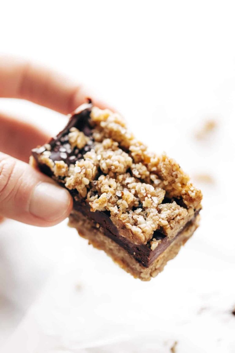 Salted chocolate snack bar held by a hand.