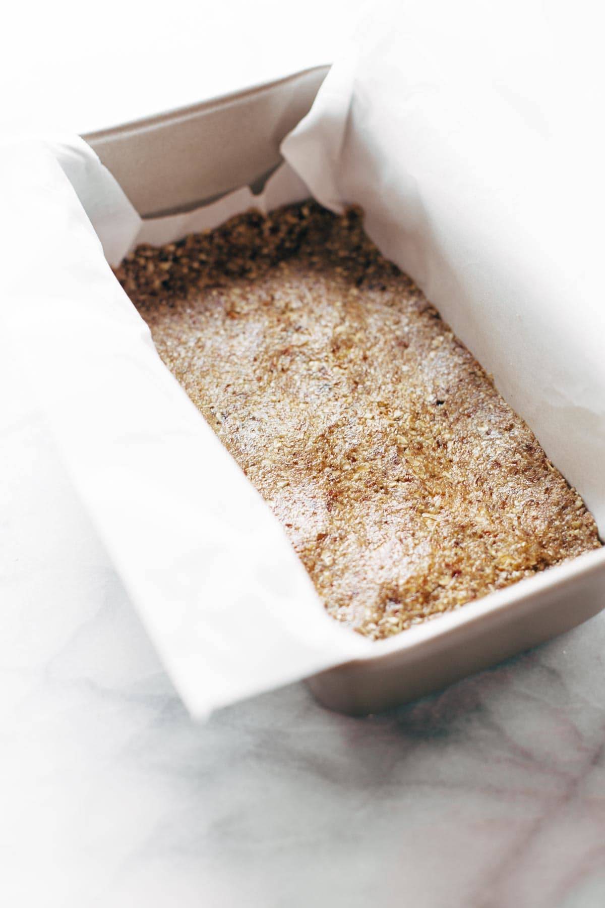 Crust for Raw Salted Chocolate Bars in a pan.