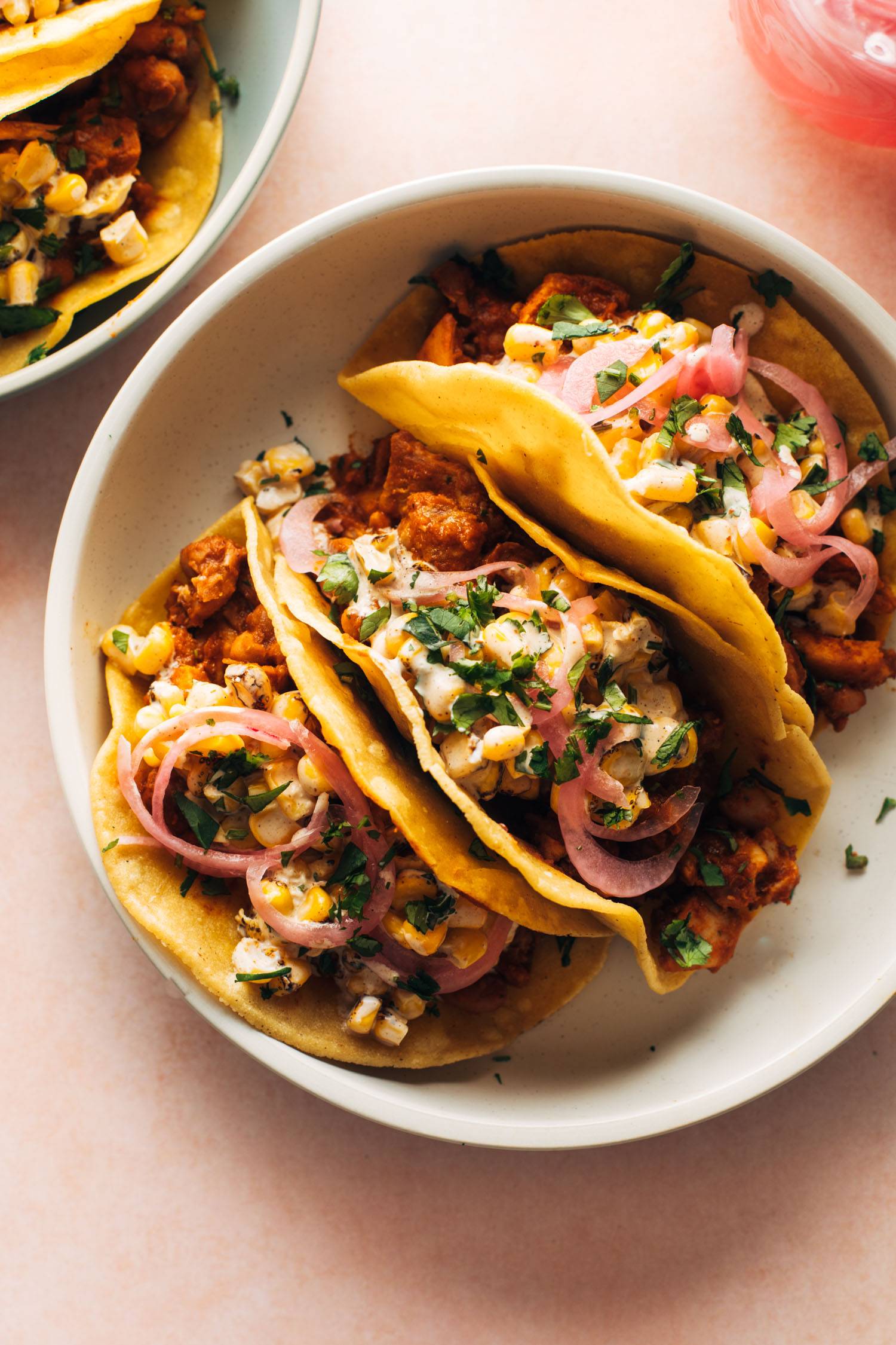 Chicken tacos on a plate with creamy corn