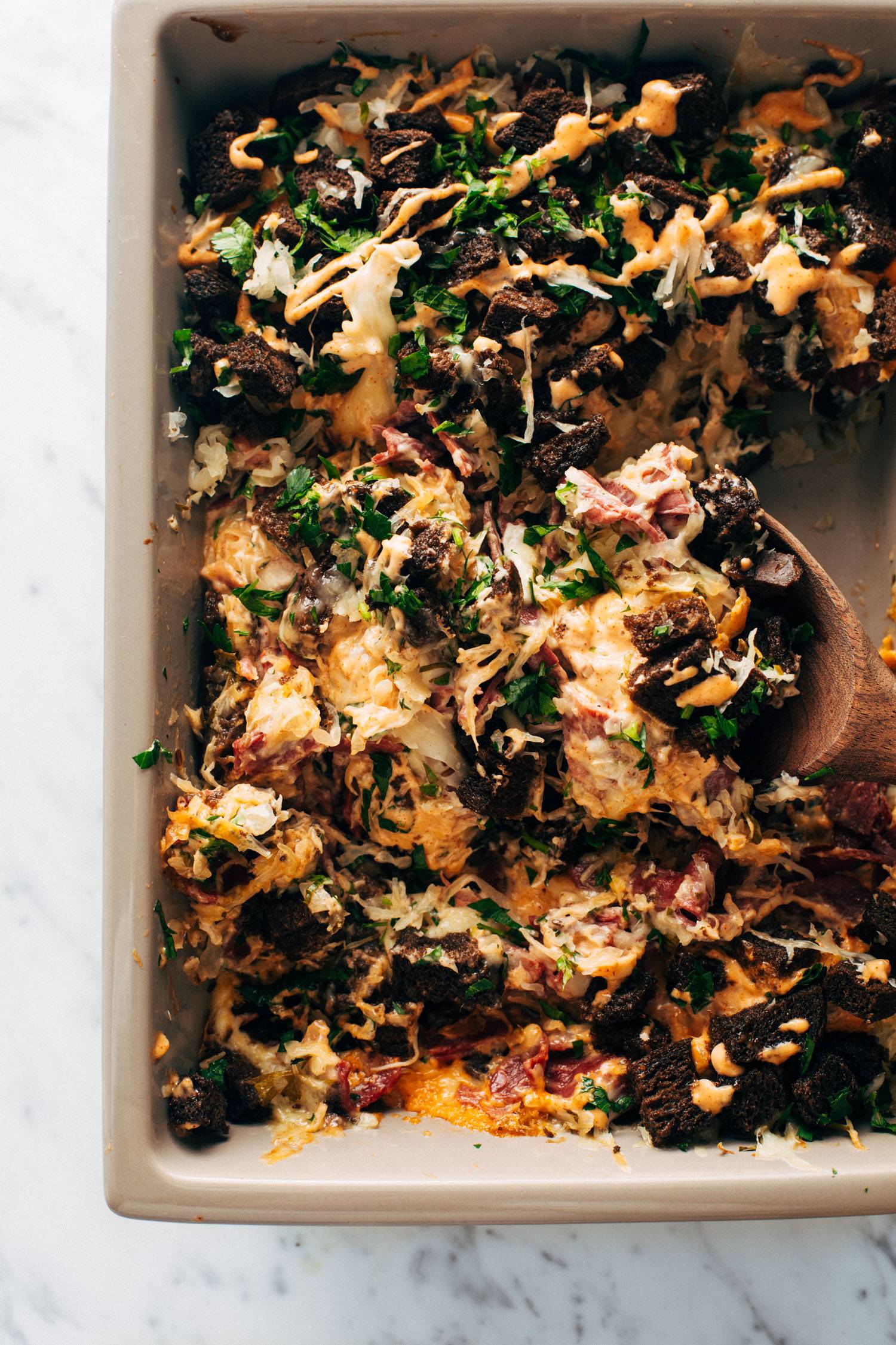 Reuben casserole in a pan with a spoon