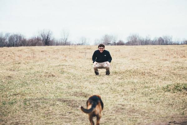 Dog running to a man.