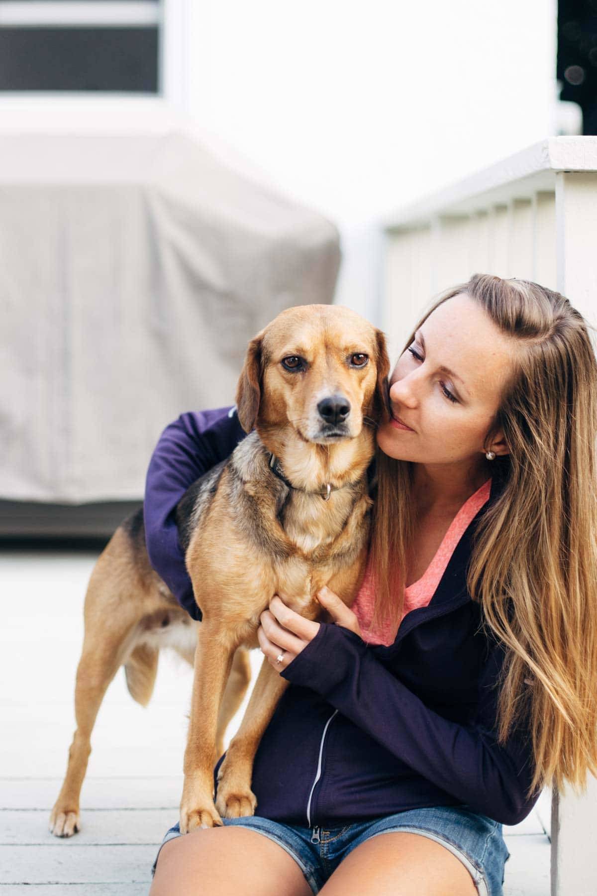 Girl holding a dog.