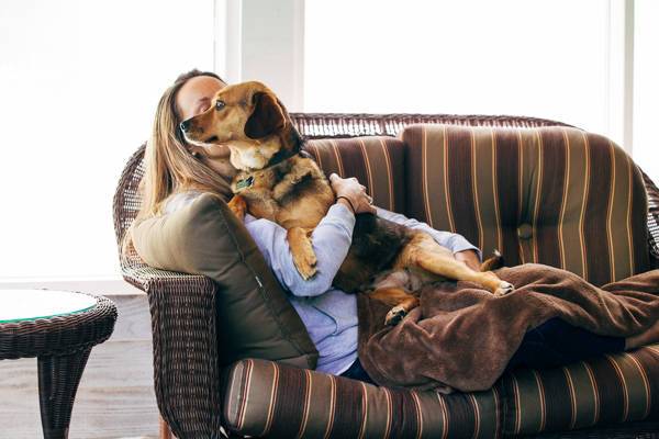 Dog and woman on a couch.