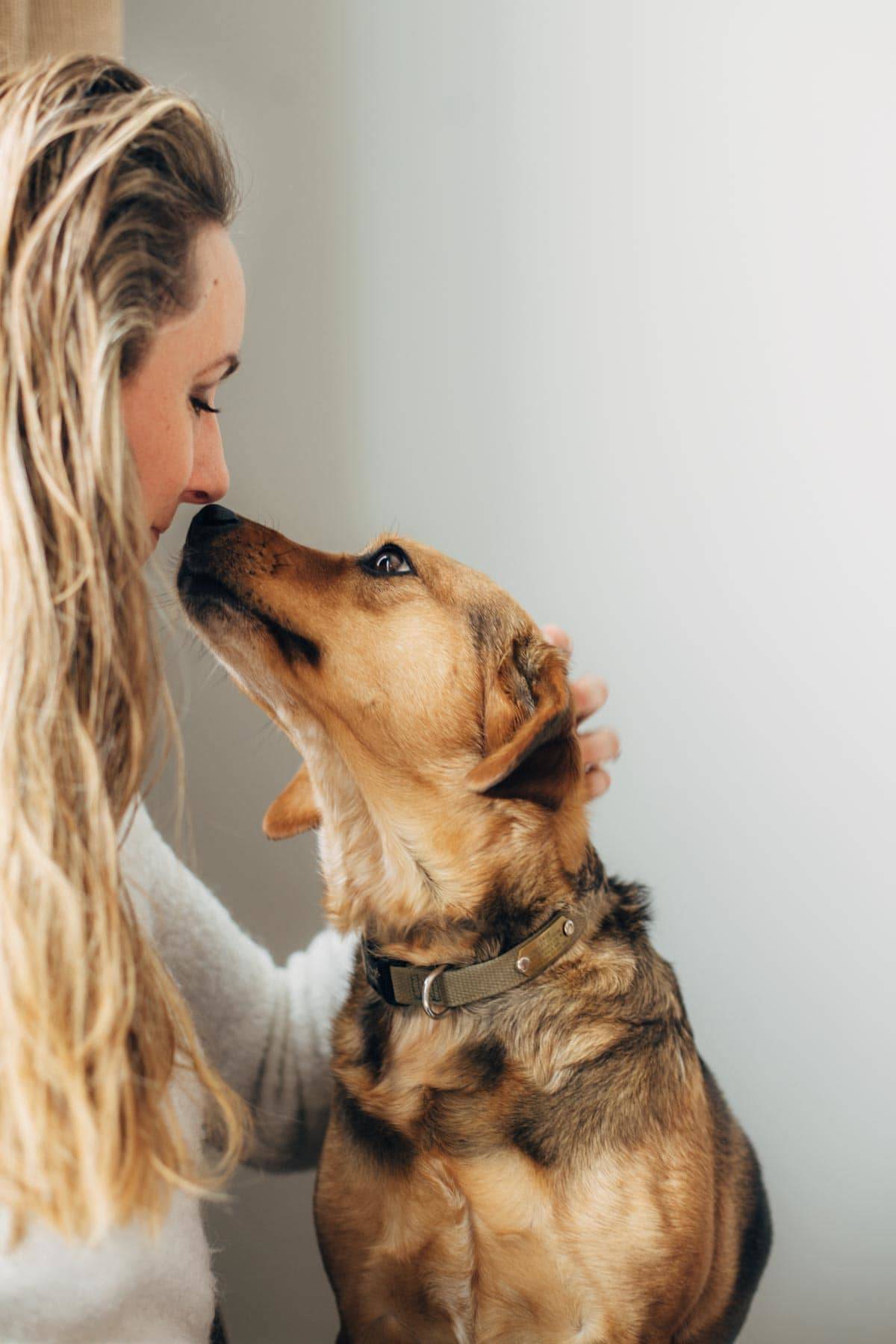 Woman and dog touching noses.