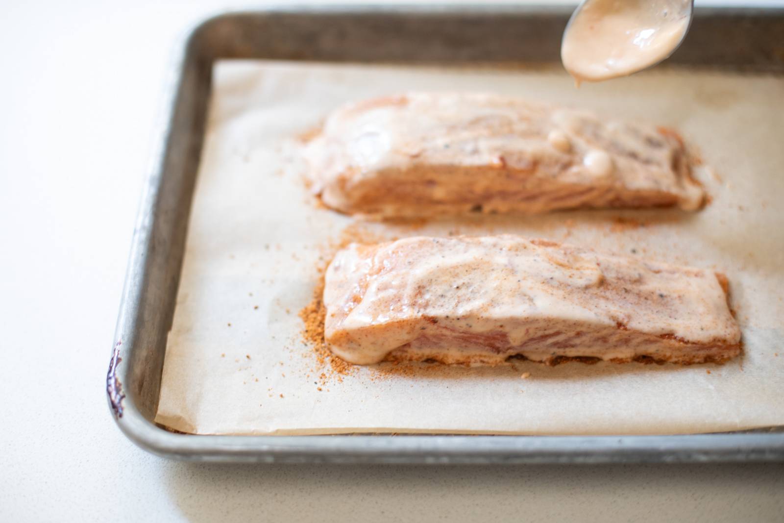 Coating salmon in bang bang sauce.