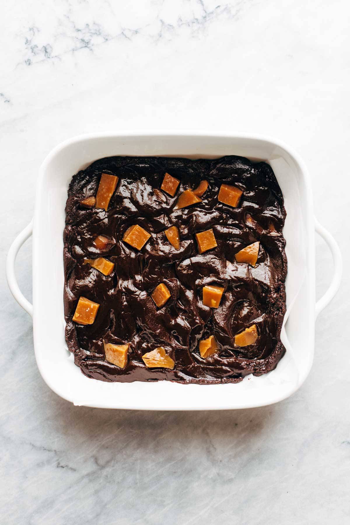 Salted caramel brownies in pan before baking.