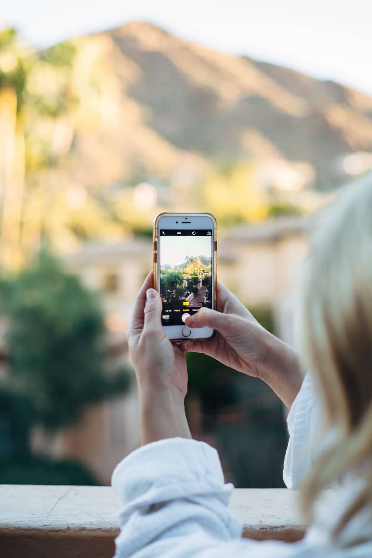 iphone taking a photo of a mountain