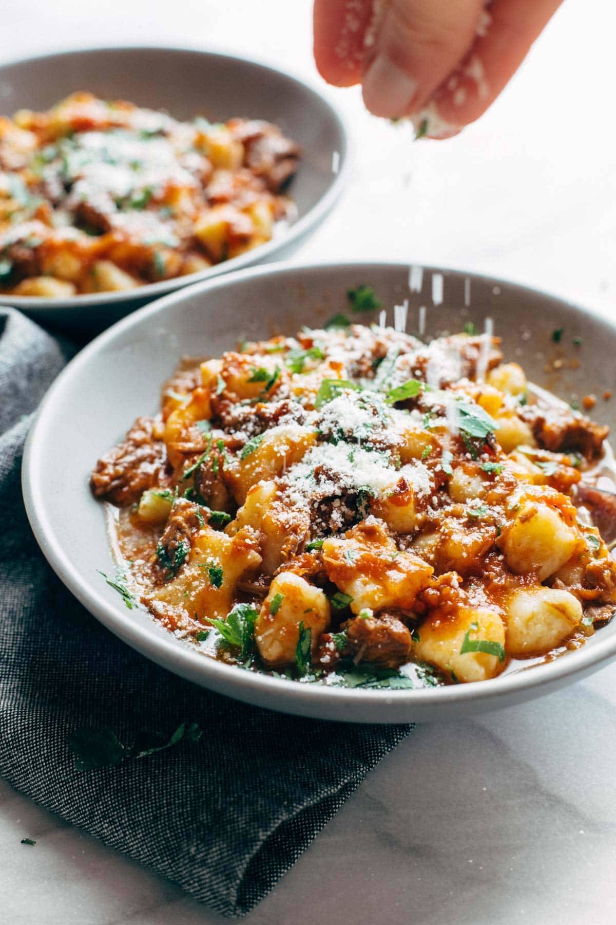 Parmesan sprinkled on Instant Pot Short Rib Ragu with gnocchi.