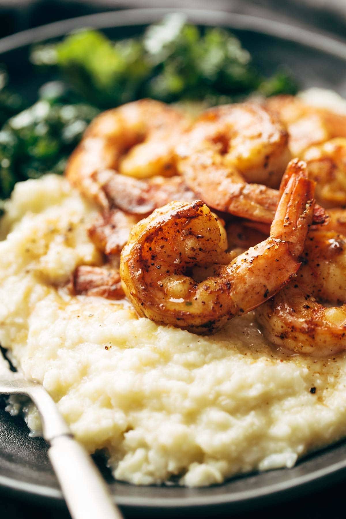 Shrimp and cauliflower mash on a plate with a fork.