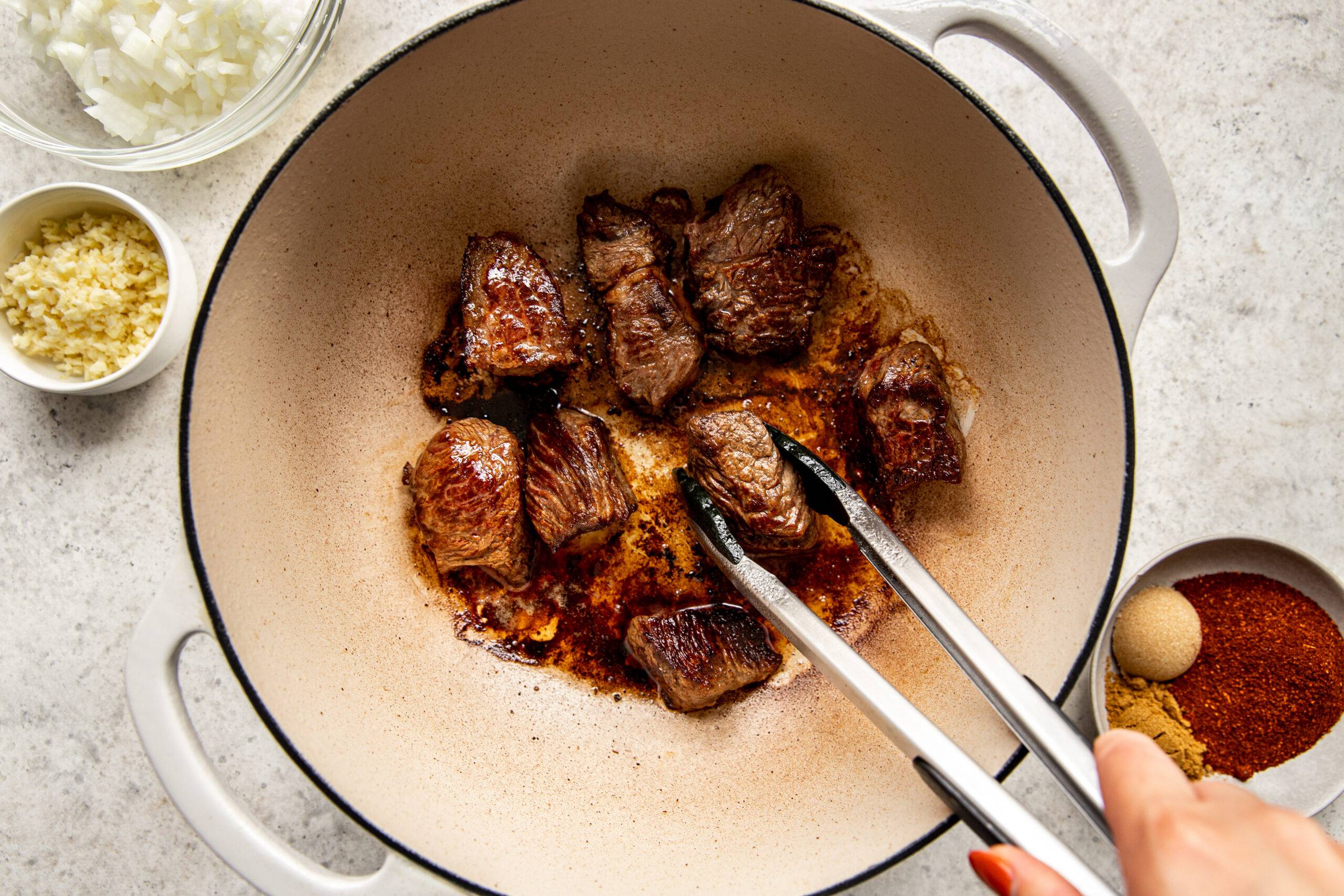 Browning beef in a dutch oven.