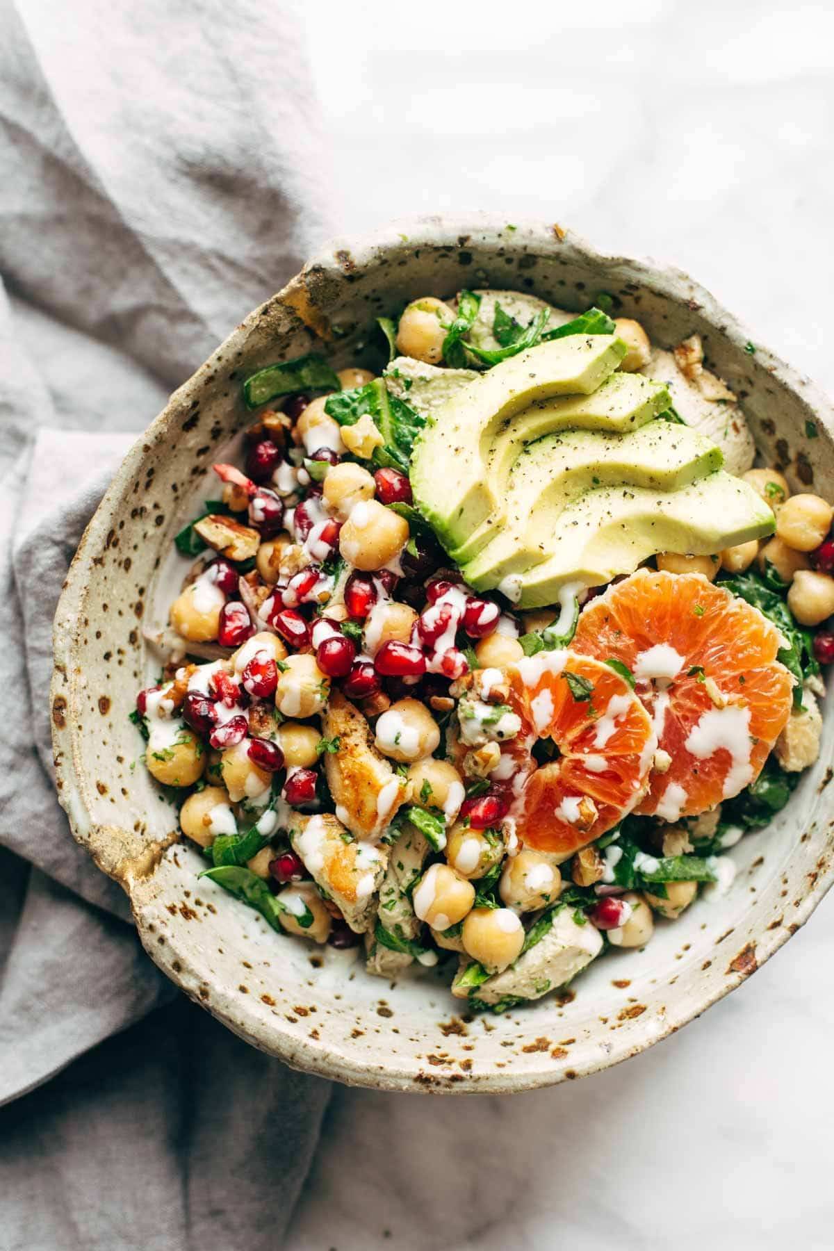 Winter Spa Salad with Lemon Chicken! Loaded with chickpeas, spinach, pomegranates, Cara Cara oranges, avocado, shallots, herbs, dressing, and lemon chicken. | pinchofyum.com